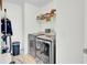 Efficient laundry room with modern washer and dryer, with organized shelving above appliances at 613 Ravens Wood Rd, Summerville, SC 29486