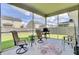Covered patio with seating, grill, and a view of the backyard with privacy fence at 613 Ravens Wood Rd, Summerville, SC 29486