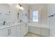 Bathroom with double vanity, soaking tub, and bright lighting at 656 Coleman Blvd # 402, Mount Pleasant, SC 29464
