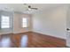 Bright bedroom with hardwood floors, white trim, and multiple windows with plantation shutters at 656 Coleman Blvd # 402, Mount Pleasant, SC 29464