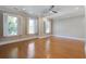 Large bedroom with hardwood floors, ceiling fan, recessed lighting, and windows providing natural light and outside views at 656 Coleman Blvd # 402, Mount Pleasant, SC 29464