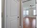 Bedroom entryway featuring hardwood floors and natural light from the shuttered window at 656 Coleman Blvd # 402, Mount Pleasant, SC 29464
