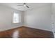Bright bedroom features hardwood floors, ceiling fan, and a window with white shutters at 656 Coleman Blvd # 402, Mount Pleasant, SC 29464