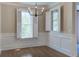 Inviting dining room with hardwood floors, paneled walls, and windows featuring elegant white shutters at 656 Coleman Blvd # 402, Mount Pleasant, SC 29464