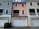 Charming townhome featuring colorful facade, attached garage, and balcony on a sunny day at 656 Coleman Blvd # 402, Mount Pleasant, SC 29464