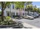 Attractive townhome exteriors with palm trees, sidewalks, and ample parking, set against a backdrop of lush greenery at 656 Coleman Blvd # 402, Mount Pleasant, SC 29464