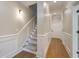Well-lit hallway with hardwood floors, carpeted stairs, and decorative wainscoting leading to various rooms at 656 Coleman Blvd # 402, Mount Pleasant, SC 29464