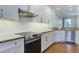 Modern kitchen features white cabinets, stainless steel appliances, granite countertops, and subway tile backsplash at 656 Coleman Blvd # 402, Mount Pleasant, SC 29464