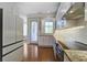 Bright kitchen featuring white cabinets, stainless steel appliances, granite countertops, and a view to the exterior at 656 Coleman Blvd # 402, Mount Pleasant, SC 29464