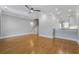 Open living room with hardwood floors, recessed lighting, ceiling fan, and a staircase leading to the upper level at 656 Coleman Blvd # 402, Mount Pleasant, SC 29464