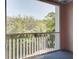 Screened patio with metal railing offers outdoor living space and views of the surrounding greenery and trees at 656 Coleman Blvd # 402, Mount Pleasant, SC 29464