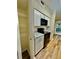 Kitchenette with white cabinets, stone countertop, and laminate flooring at 700 Daniel Ellis Dr # 2203, Charleston, SC 29412