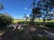 Marshy area with trees, a bench, and blue skies in the distance at 700 Daniel Ellis Dr # 2203, Charleston, SC 29412