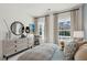 Well-lit bedroom with two windows and stylish decor, including a dresser and round mirror at 751 Maynard Ln, Summerville, SC 29486