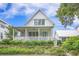 Charming two-story home with a covered porch and beautifully landscaped front yard at 7935 Flagship Ln, Johns Island, SC 29455