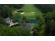 An aerial view of a cozy house in a neighborhood, with a pond, fountain, and golf course in the background at 806 Westos Way, Mount Pleasant, SC 29464