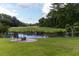 Landscaped backyard with lake views, seating area, and fire pit at 806 Westos Way, Mount Pleasant, SC 29464