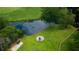 A pond, fire pit, seating, and lush green grass create the perfect backyard for this charming home at 806 Westos Way, Mount Pleasant, SC 29464