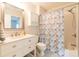Bright bathroom featuring a white vanity, toilet, and shower-tub combo with a patterned shower curtain at 806 Westos Way, Mount Pleasant, SC 29464