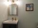 Stylish powder room featuring a modern vanity, decorative mirror, and contemporary lighting fixtures at 806 Westos Way, Mount Pleasant, SC 29464