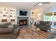 Cozy living room with fireplace and built-in shelving offers comfortable seating and sliding door access at 806 Westos Way, Mount Pleasant, SC 29464