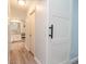 Hallway view with white sliding door leading to a bathroom with double sinks and ample storage at 806 Westos Way, Mount Pleasant, SC 29464