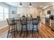 Kitchen island boasts stone counters, seating, and stainless appliances at 806 Westos Way, Mount Pleasant, SC 29464