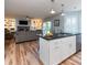 Kitchen island boasts stone counters with sink and dishwasher, with an open floor plan leading to the living room at 806 Westos Way, Mount Pleasant, SC 29464