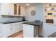 Bright kitchen boasts white cabinetry, sleek countertops, tile backsplash and modern lighting at 806 Westos Way, Mount Pleasant, SC 29464
