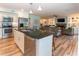 Kitchen with stainless appliances is open to the living room with fireplace and built-in bookcases at 806 Westos Way, Mount Pleasant, SC 29464