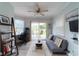 Cozy living area with a futon, desk, ceiling fan and sliding glass door to backyard at 806 Westos Way, Mount Pleasant, SC 29464