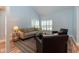 Living room with high ceiling, shuttered windows, comfortable seating, and a striped area rug at 806 Westos Way, Mount Pleasant, SC 29464