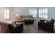 A comfortable living room with soft lighting, a neutral sofa with pillows, and dark leather chairs at 806 Westos Way, Mount Pleasant, SC 29464