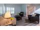 A cozy living room with shuttered windows, a comfy sofa, two chairs, and hardwood floors at 806 Westos Way, Mount Pleasant, SC 29464