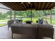 Charming screened-in porch featuring comfortable seating and picturesque views of the lush backyard and pond at 806 Westos Way, Mount Pleasant, SC 29464