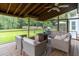 Relaxing screened-in porch features comfortable seating, a ceiling fan, and scenic views of the backyard at 806 Westos Way, Mount Pleasant, SC 29464