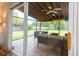 Spacious screened-in porch boasts a ceiling fan, comfortable seating, and scenic backyard views at 806 Westos Way, Mount Pleasant, SC 29464