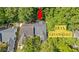 Aerial view of a home with new roof among other well-maintained properties and greenspace at 9117 Woodcreek Ct, North Charleston, SC 29406