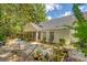 Secluded backyard with a hammock, mature trees, privacy fence, and an inviting patio area at 9117 Woodcreek Ct, North Charleston, SC 29406