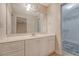 Bathroom featuring vanity with white cabinets, large mirror, and walk-in closet at 9117 Woodcreek Ct, North Charleston, SC 29406