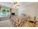 Comfortable bedroom with natural light, ceiling fan, and a butterfly-themed bedspread at 9117 Woodcreek Ct, North Charleston, SC 29406