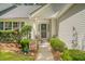 Inviting front entrance with manicured bushes, potted flowers and decorations at 9117 Woodcreek Ct, North Charleston, SC 29406