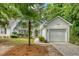 Charming one-story home with an attached garage and beautifully landscaped front yard with a palm tree at 9117 Woodcreek Ct, North Charleston, SC 29406