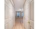 Hallway featuring multiple doors and light wood-look floors at 9117 Woodcreek Ct, North Charleston, SC 29406