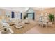 Airy living room with vaulted ceilings and modern décor, bathed in natural light from the windows at 9117 Woodcreek Ct, North Charleston, SC 29406