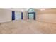 Spacious living room featuring vaulted ceilings, large windows, and light-colored carpet at 9117 Woodcreek Ct, North Charleston, SC 29406