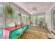 Cozy sunroom with plenty of windows, ceiling fan, and ample space for plants and seating at 9117 Woodcreek Ct, North Charleston, SC 29406