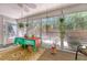 Inviting sunroom with lots of light, a ceiling fan, decorative plants and room for seating at 9117 Woodcreek Ct, North Charleston, SC 29406