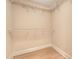 Spacious walk-in closet with a built-in shelving system and light wood flooring at 9117 Woodcreek Ct, North Charleston, SC 29406