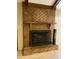 Cozy living room fireplace with a classic brick surround and wooden mantle at 109 Garbon Dr, Summerville, SC 29485